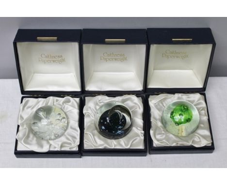 A "CAITHNESS" LIMITED EDITION GLASS PAPERWEIGHT "First Quarter" no.1319/1500 boxed, together with TWO OTHER "CAITHNESS" PAPER