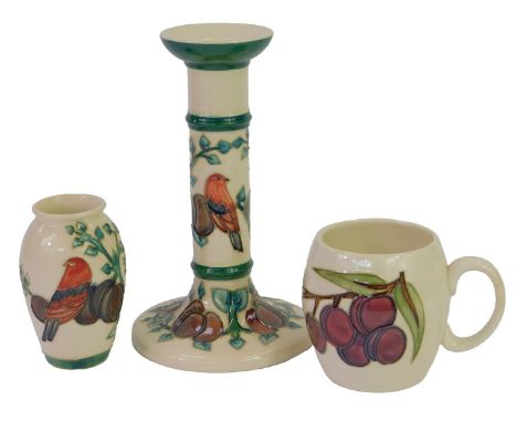 A group of Moorcroft Plum pattern pottery, designed by Sally Tuffin, initially for Liberty, comprising a candlestick, 20.5cm 