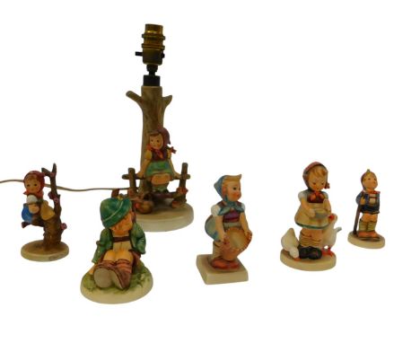 A group of Goebel Hummel, to include a table lamp, modelled as a young girl beside a basket seated on a bench, 27cm high, and