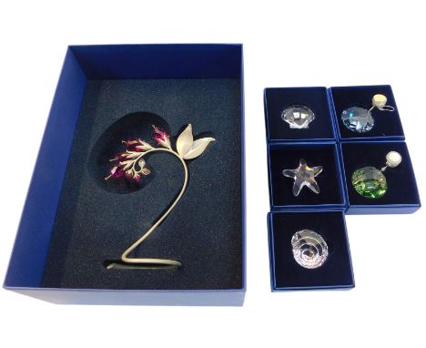 A group of Swarovski crystal, to include a floral display, mounted on a metal base, 20cm high, and a group of Christmas tree 