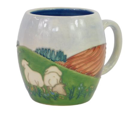 A Moorcroft pottery Sheep pattern mug, impressed marks and initialled WM, 9cm high. 
