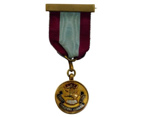 A 9ct gold and enamel LBC Bradford Jubilee medal, named to Bro Wilfred Hiles Chief Ranger 1933, on a blue and burgundy ribbon