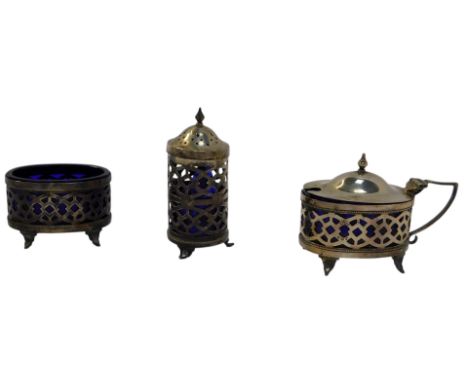 A George V silver three piece cruet, comprising lidded mustard pot, open salt and pepper pot, each of pierced form, with blue