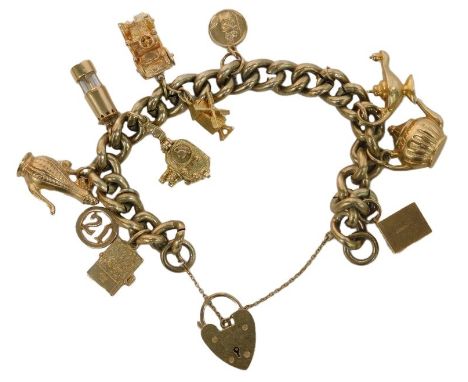 A gold plated curb link charm bracelet, with a heart-shaped padlock and safety chain as fitted, with ten 9ct gold charms atta