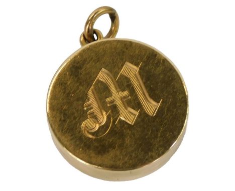 A Victorian locket, of circular form, engraved with the initial M, bearing a portrait of a lady, yellow metal, marked 18ct, 1