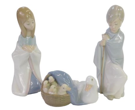 Three Lladro porcelain figures, modelled as a girl kneeling with hands clasped, 15cm high, a boy wearing a cloak, holding a s