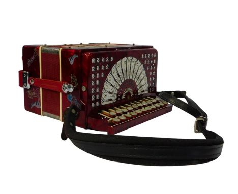 A Dino Baffetti Castelfidardo button accordion, in red, cased.