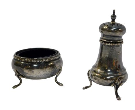 A George V silver part cruet, comprising open salt with blue glass liner, and a pepper pot, Birmingham 1926 and 1929, weighab