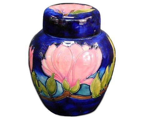 A Moorcroft pottery ginger jar and cover decorated in the Magnolia pattern, dark blue ground, impressed marks and signed, 15c