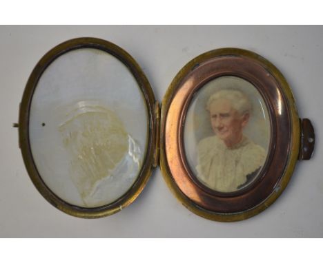 An oval portrait miniature of an old lady, circa 1900, in brass and mother of pearl pocket case