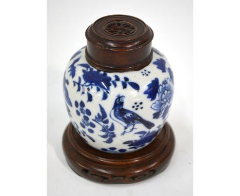 A Chinese blue and white oviform vase, 9cm high, Kangxi four-character mark but not of the period together with a wood stand 