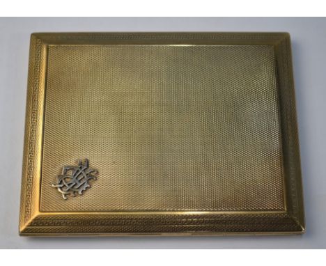 A 9ct yellow gold slide action engine turned cigarette case having applied monogram, approx 4 ozs including elastic retainer,