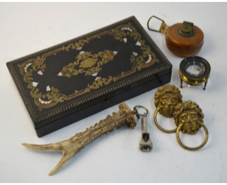 A 19th century Continental ebony trinket box, inlaid with brass and mother-of-pearl, containing collectables including roe de