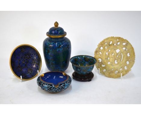 A reticulated jade, or other stone, carved with a reticulated design, 12cm diameter; together with four items of Chinese cloi