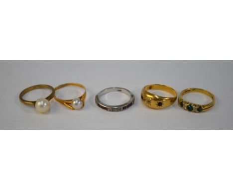 A collection of five rings including ruby and diamond half eternity, green stone and diamond ring, ruby and diamond gypsy set