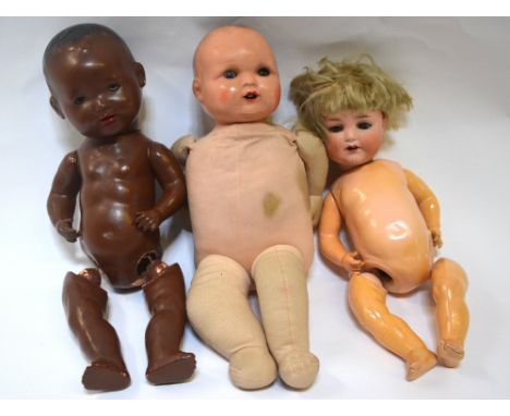 An Armand Marseille 996 A4M doll, a 'Dollies' 3 black doll, another doll with soft body, a collection of dolls' clothes, a bo
