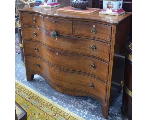 A large George III ebony inlaid mahogany serpentine chest of three short over three long graduated drawers, raised over a sha