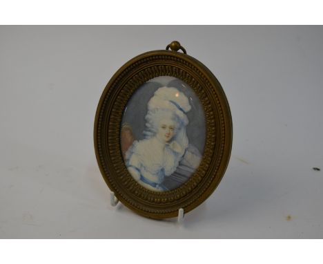 An oval portrait miniature on ivory of an 18th century lady of fashion, signed T.(?) Lawrence 1791 and inscribed on reverse o