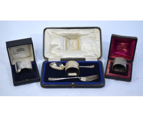 A cased Christening set with spoon, fork and napkin ring, Sheffield 1922/23, to/w two cased napkin rings, Sheffield 1892 and 