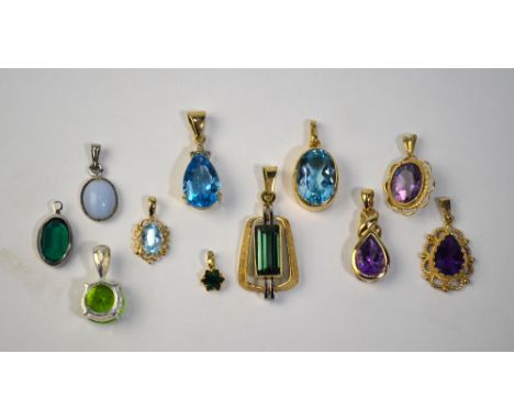 A collection of eleven stone set pendants, some 9ct, including amethyst, blue topaz, spinnel etc