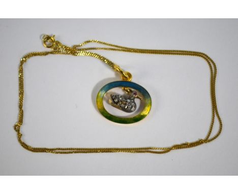 A yellow gold blue and green enamel pendant having diamond set duck with ruby eye suspended in centre, on yellow gold chain s