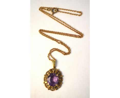An oval amethyst claw set pendant in pierced and cast 9ct mount, hung onto  fine link yellow metal chain, approx 4.7g all in