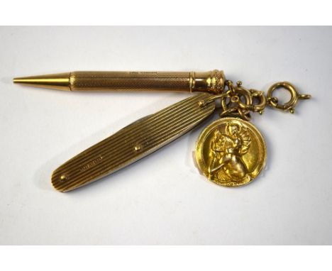 A 9ct cased yellow gold reeded penknife to/w 9ct engine turned propelling pencil and 9ct St Christopher, all linked by three 
