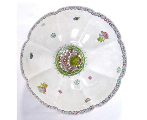 A  famille rose 'egg-shell' bowl, decorated with dragon and floral designs, 27cm diameter, Qianlong mark but not of the perio