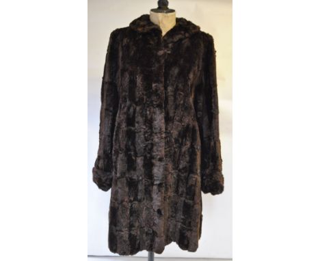 A mink fur stole with scalloped edges, mink collar, a pair of cuffs with four mink tails on each, a mid-brown squirrel fur co