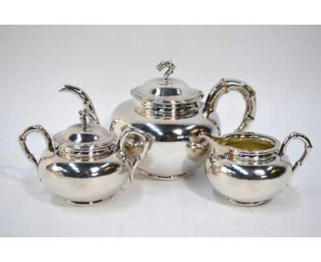 A Chinese white metal part tea-service comprising: a teapot with domed cover and bamboo sprig finial; sugar basin with handle