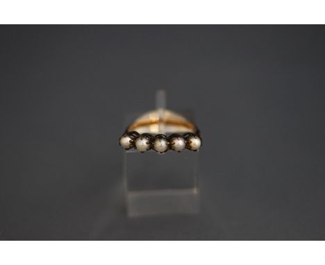 A five stone pearl ring, stamped '14ct', the pearls (untested and unwarranted) of approximately 3.5 mm diameter, finger size 