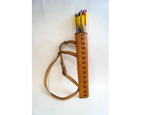 A leather archery quiver with a dozen arrows and a cows horn hunting horn with plated mounts