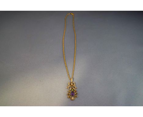 An Edwardian amethyst, demantoid garnet and seed pearl pendant, stamped '9ct'; on rope link chain