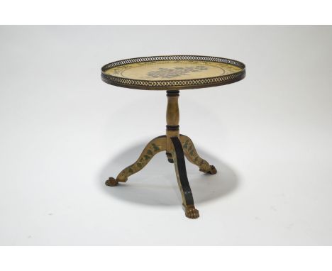 A painted occasional table, the circular top with rose decoration within a brass gallery, on carved reeded tripod legs and gi