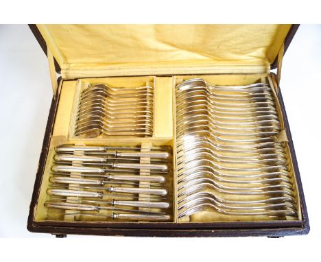 A French silver plated canteen of fiddle thread and shell cutlery, twelve place setting, comprising twelve dinner knives, din