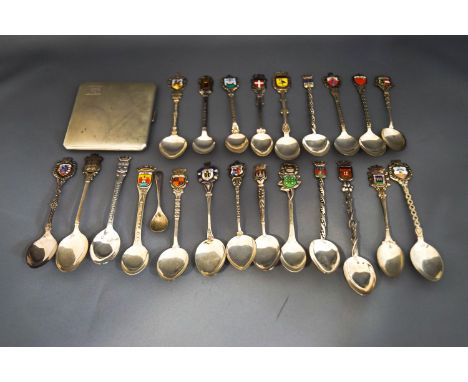 A collection of silver and plated tourist spoons; and a silver cigarette case