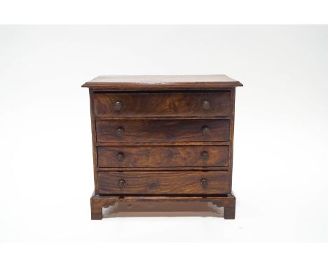 A George III style mahogany table top set of four drawers, with brass handles, upon bracket feet, 31cm high x 33cm wide x 20.