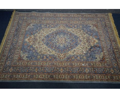 A 20TH CENTURY PERSIAN WOOL RUG, with light blue and cream ground, 199cm x 139cm