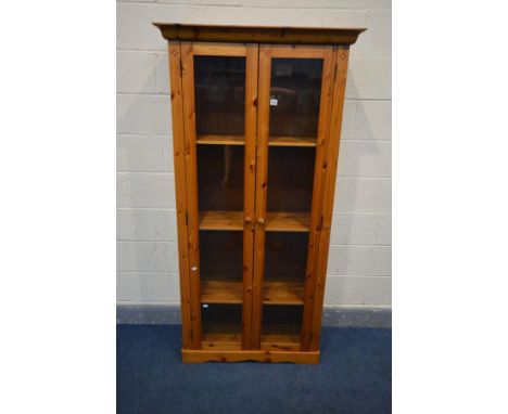 A PINE DOUBLE DOOR GLAZED BOOKCASE with three adjustable shelves and internal lighting, width 90cm x depth 41cm x height 179c