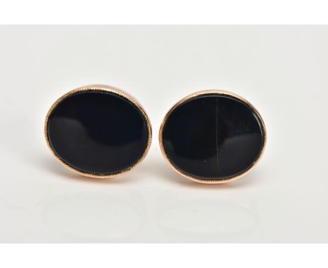 A PAIR OF YELLOW METAL ONYX EARRINGS, each designed with an oval onyx, collet mounted, approximate dimensions 12.4mm x 10.8mm