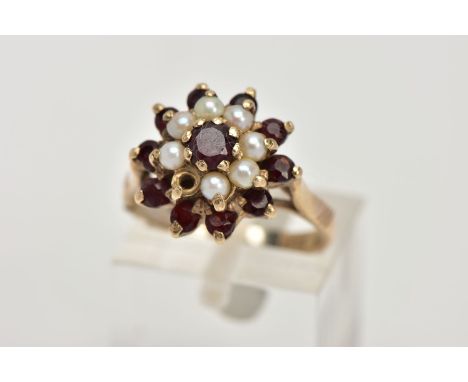 A GEM CLUSTER RING, designed as a tiered cluster of claw set red gems assessed as garnets and split pearls, one pearl missing