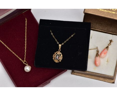 TWO PENDANT NECKLACES AND A PAIR OF CORAL DROP EARRINGS, the first pendant of an oval form, centring on an oval cut garnet wi