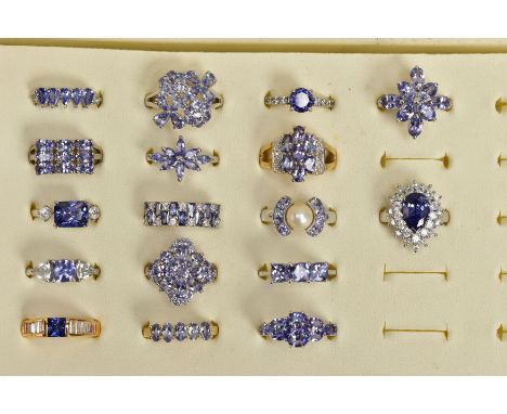 SEVENTEEN GEM SET RINGS AND A RING BOX, most set with vary cut tanzanite's, to include clusters, half eternity, there stone r