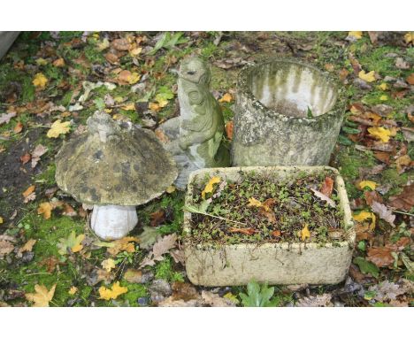 TWO COMPOSITE GARDEN ORNAMENTS, a mushroom with a fairy to top and a putto holding a fish water feature top together with a c