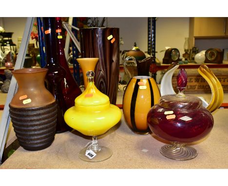 TEN LARGE GLASS VASES, BOWLS, ETC to include two lidded pedestal bowls, a tall red bottle with stopper, approximate height 61