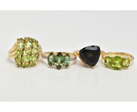 FOUR 9CT GOLD GEMSET RINGS, to include a three stone ring, oval cut peridot, prong set with tapered polished shoulders, fifte