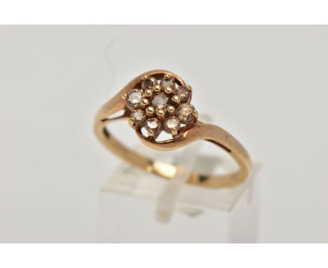 A 9CT GOLD BROWN DIAMOND CLUSTER RING, the cluster of a flower shape, set with nine round brilliant cut diamonds, total estim