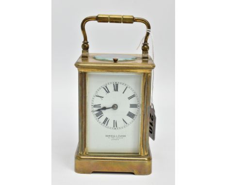 A 'HOWELL &amp; JAMES' BRASS CARRIAGE CLOCK, white dial signed 'Howell &amp; James' to the-Queen London, Roman numerals, with