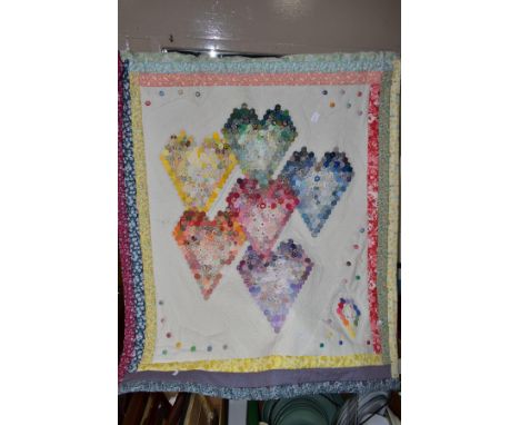 A PATCHWORK QUILT, with rod for hanging, backed in a floral print, featuring six different colour hearts, each made up from 2