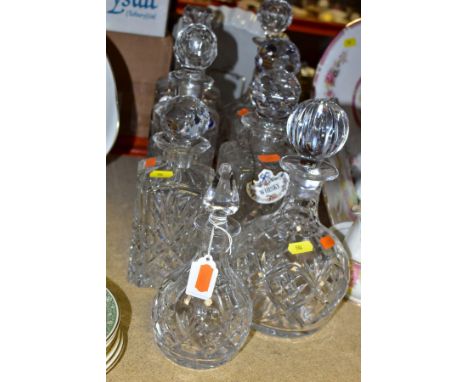 EIGHT CUT GLASS DECANTERS, comprising eight decanters with stoppers, three ceramic whisky and port labels, makers to include 